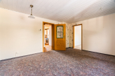 Wohnzimmer - Wohnen mit Mehrwert – 3-Zimmer-Eigentumswohnung inklusive Garage und kleiner Gartenfläche